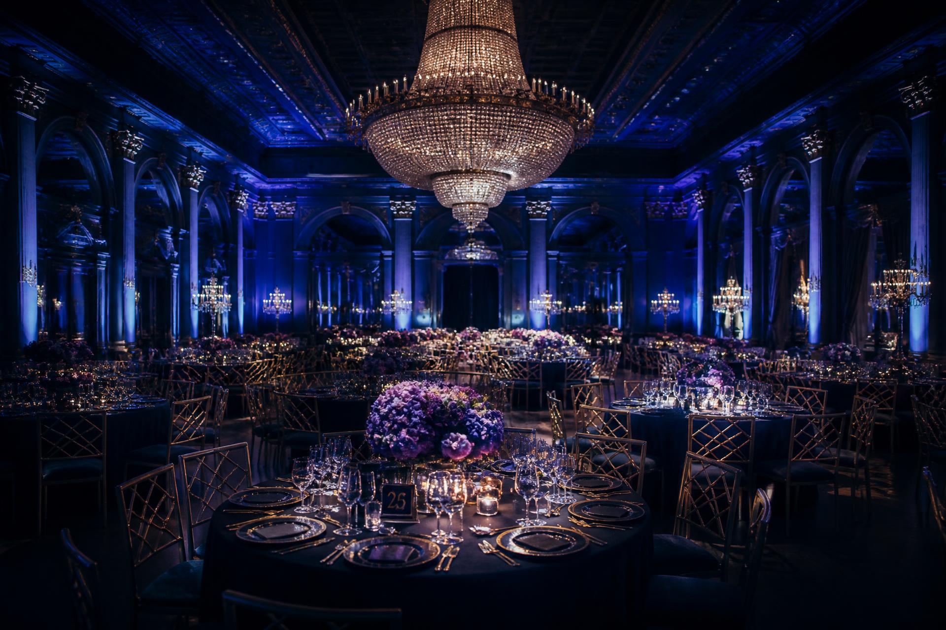 Grand ballroom lit in royal blue for a formal gala